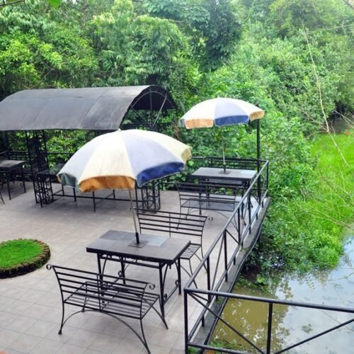 Open-air lounge area surrounded by nature with a scenic view of the Kelani River at Ambalama Leisure Lounge, Colombo