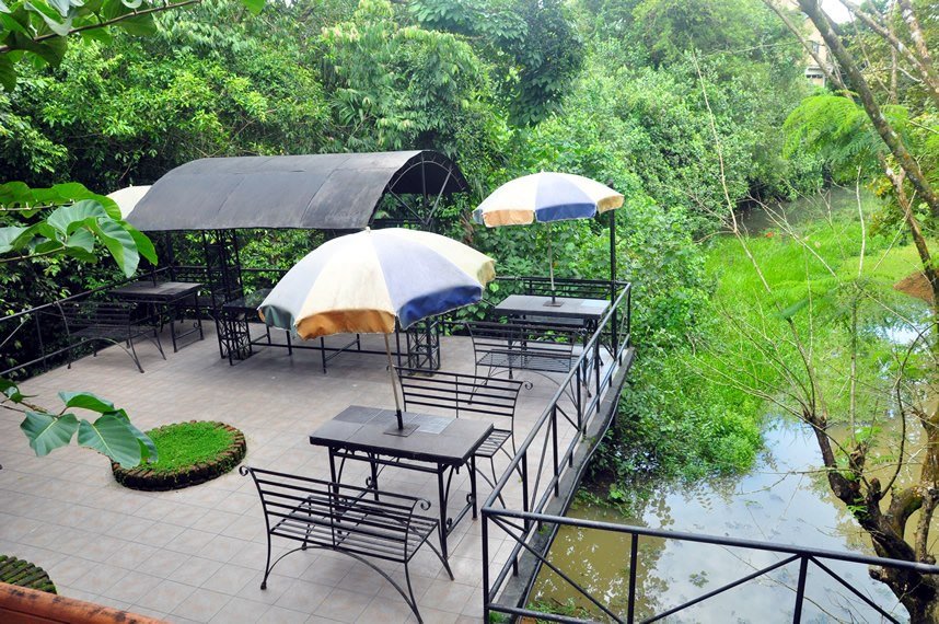 Open-air lounge area surrounded by nature with a scenic view of the Kelani River at Ambalama Leisure Lounge, Colombo